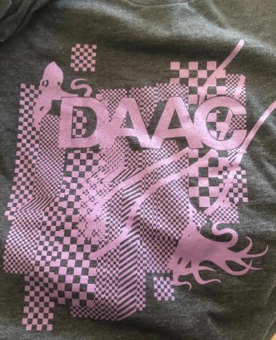 Graphic tee with DAAC artwork has pink ink on a heather gray t-shirt