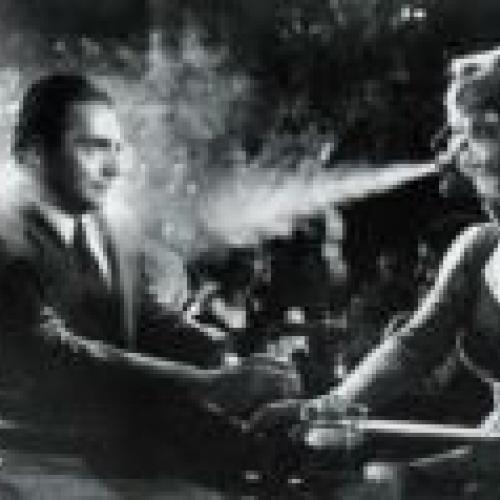 A woman blows smoke at a man in an old timey bar