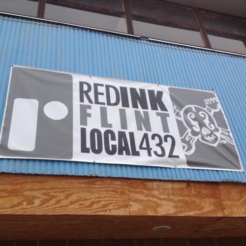 Banner on the side of a building reads REDINK Flint Local 432