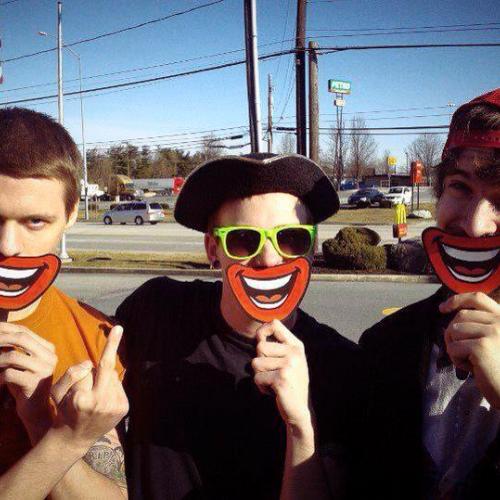 Three men standing on the street holding smiley face signs in front of their mouths